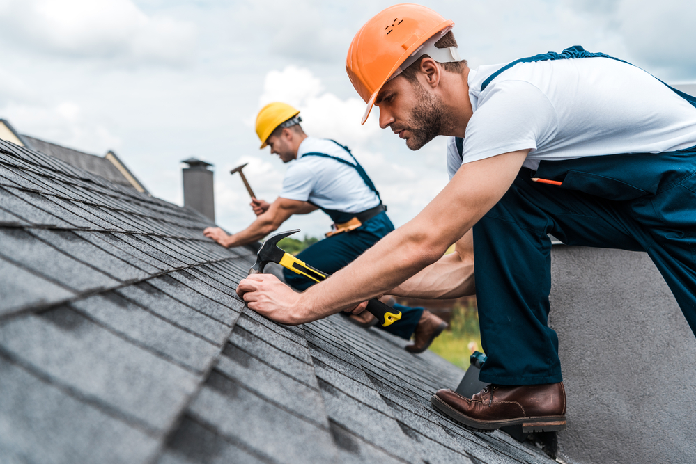 two roofers doing roof replacement